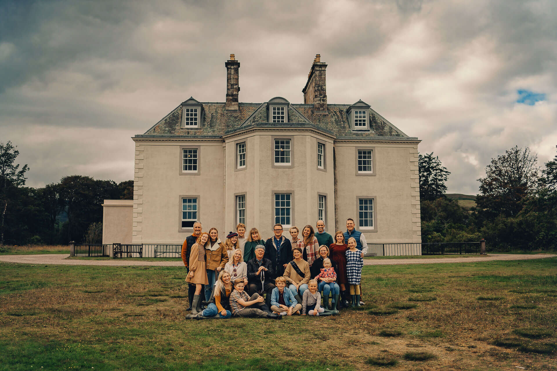 Large family gathering in front of house.