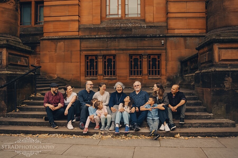 Family sitting on the steps of Kelvingrove Musem.