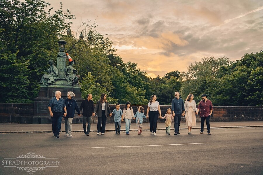 Family walking together at sunset during extended family photo session Kelvin Bridge.
