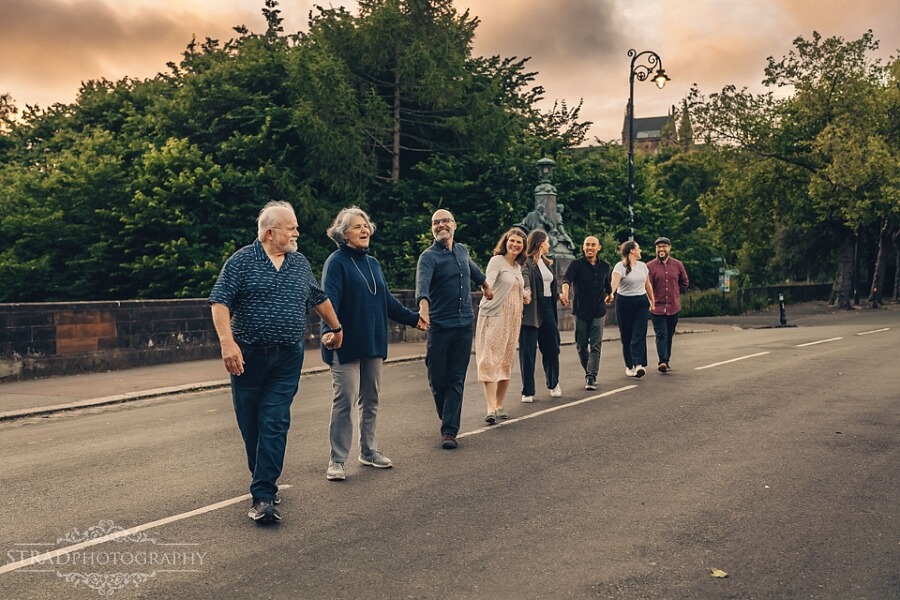 Family walking together on a street.