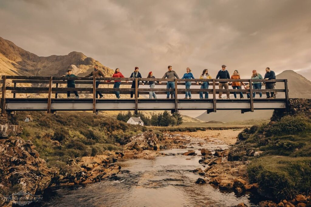 Family on bridge over scenic river