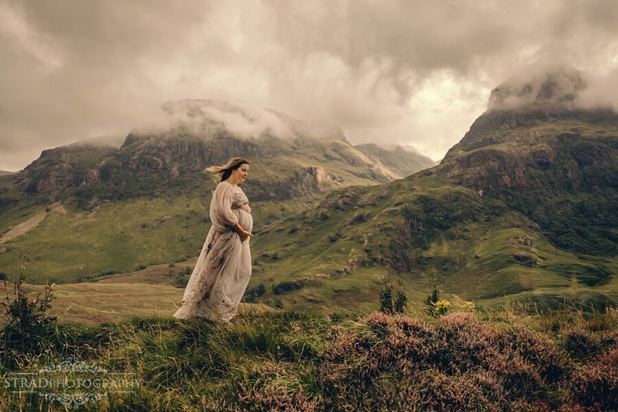 Pregnant woman in scenic mountain landscape at Three sisters of Glencoe..