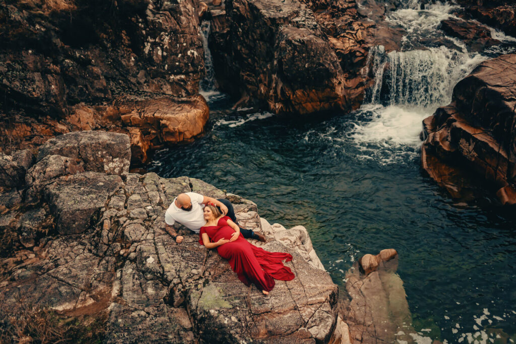 Couple relaxing by a waterfall.