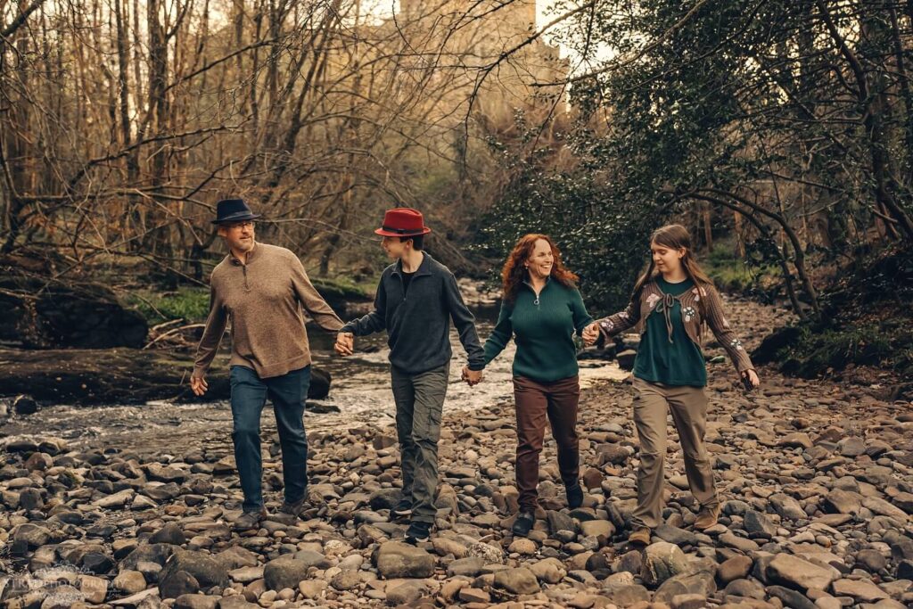Family walking hand in hand outdoors.