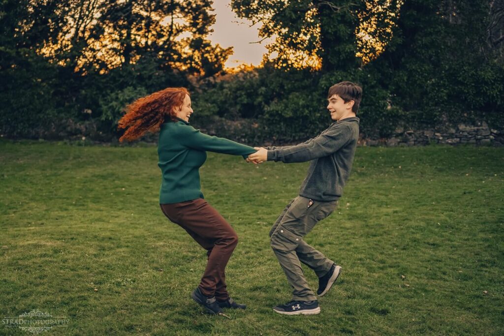 Two people playfully holding hands outdoors.