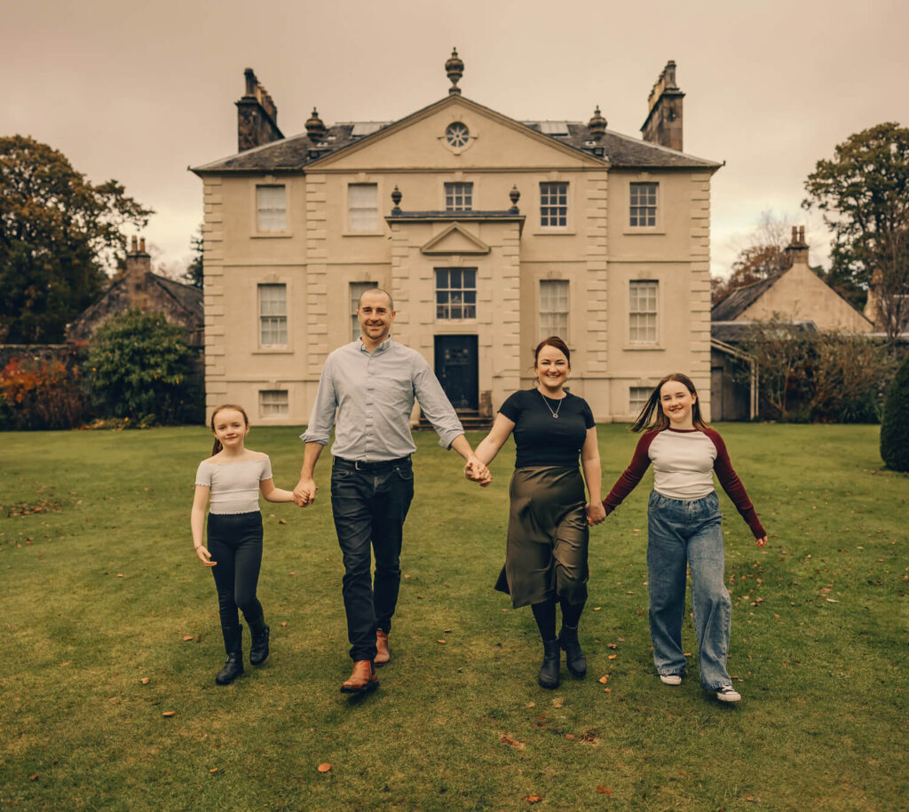 Family walking together in garden.