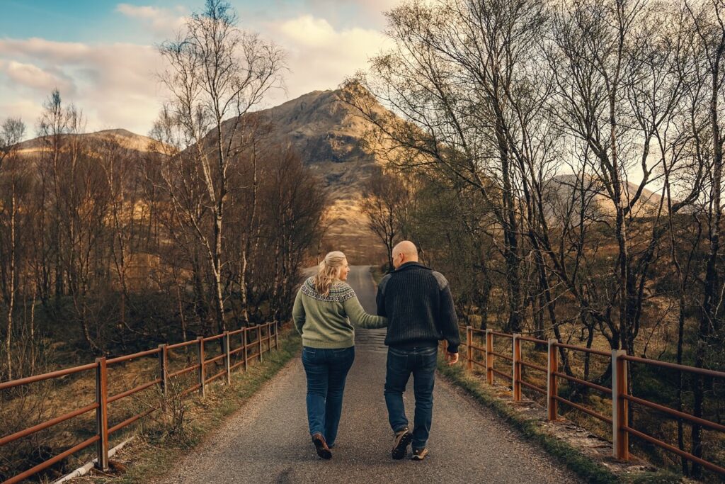Couple walking on scenic pathway together.