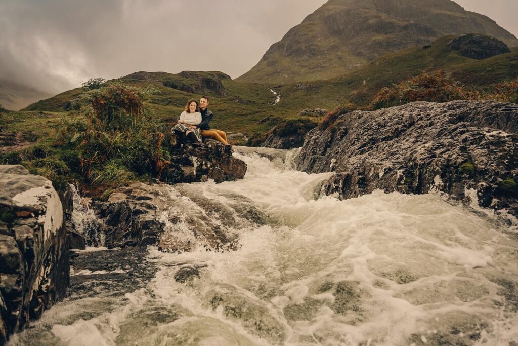 couple embracing rain glencoe photoshoot