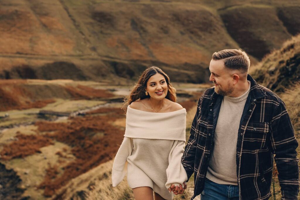 Couple walking in scenic countryside.