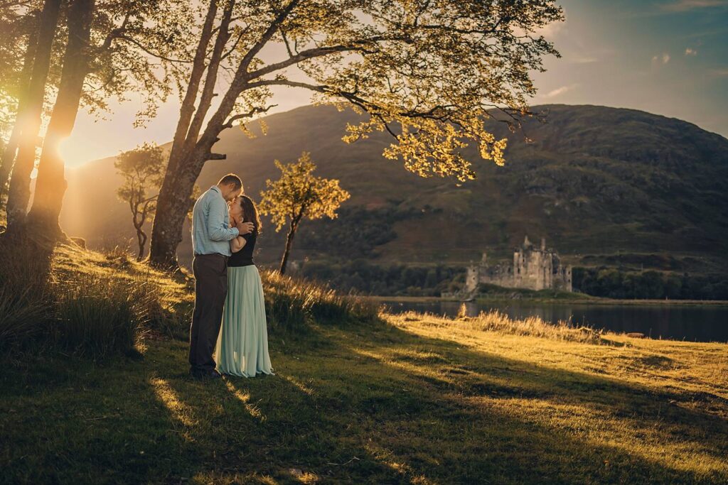 Couple embracing near Kilchurn Castle.