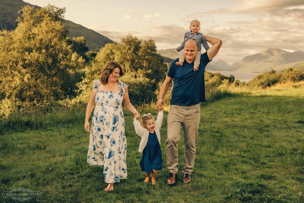 Family walking in scenic countryside.