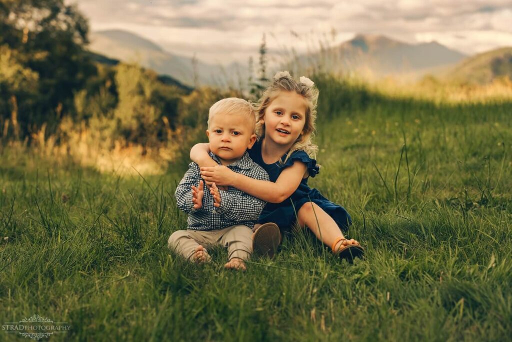 Children sitting together in nature.