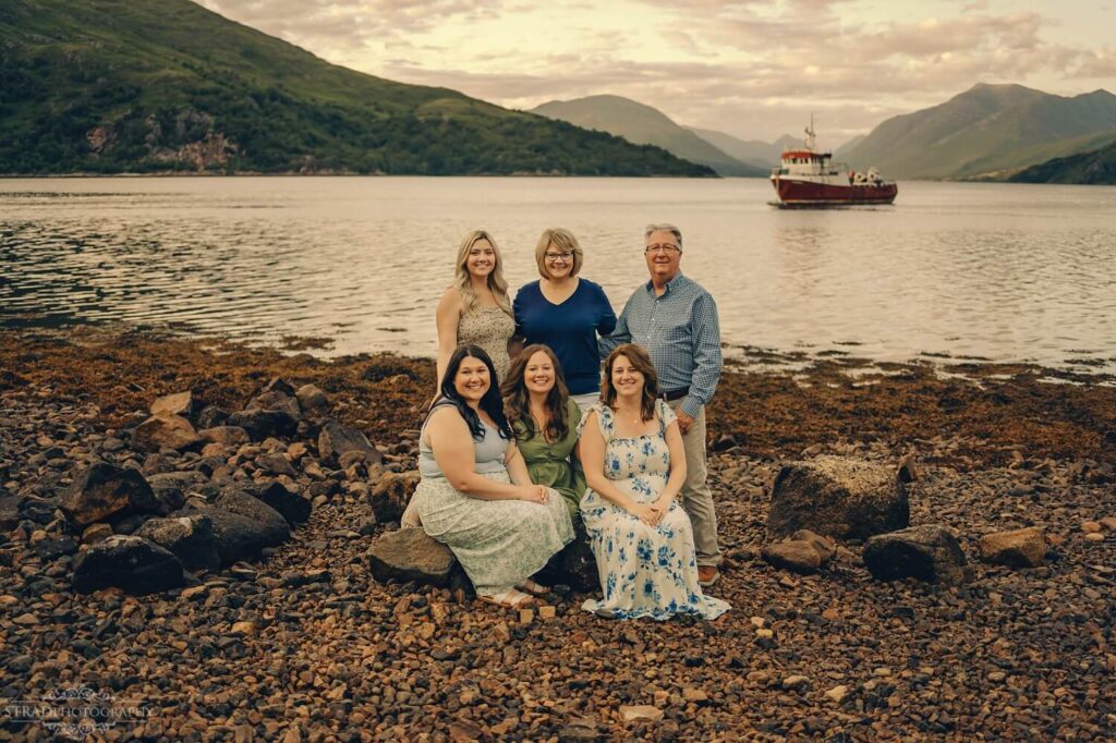 Family by the water, scenic backdrop.