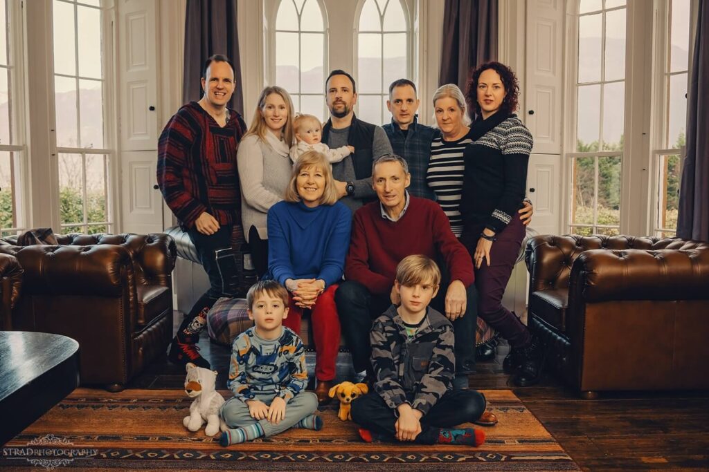 Large family gathering in cosy setting.