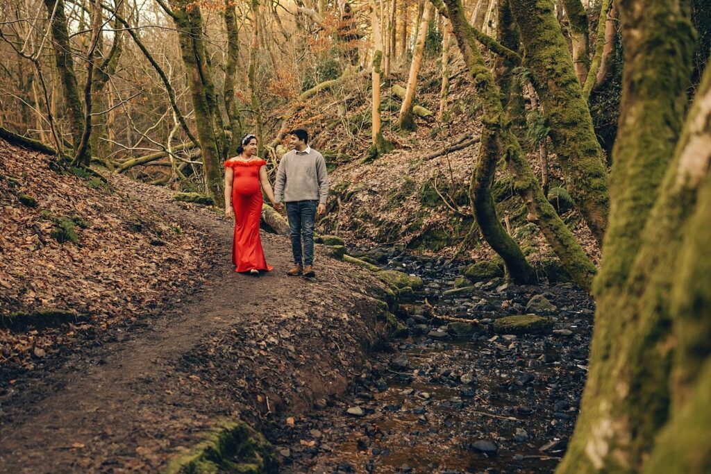 Couple walking in wooded area.